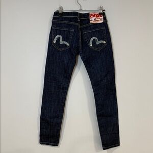 Evisu women’s dark blue wash jeans with signature painted back pockets and patch
